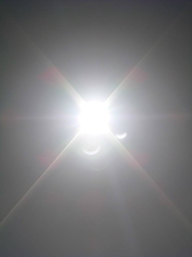 A flared image of the eclipse with the illusion of moons around it.